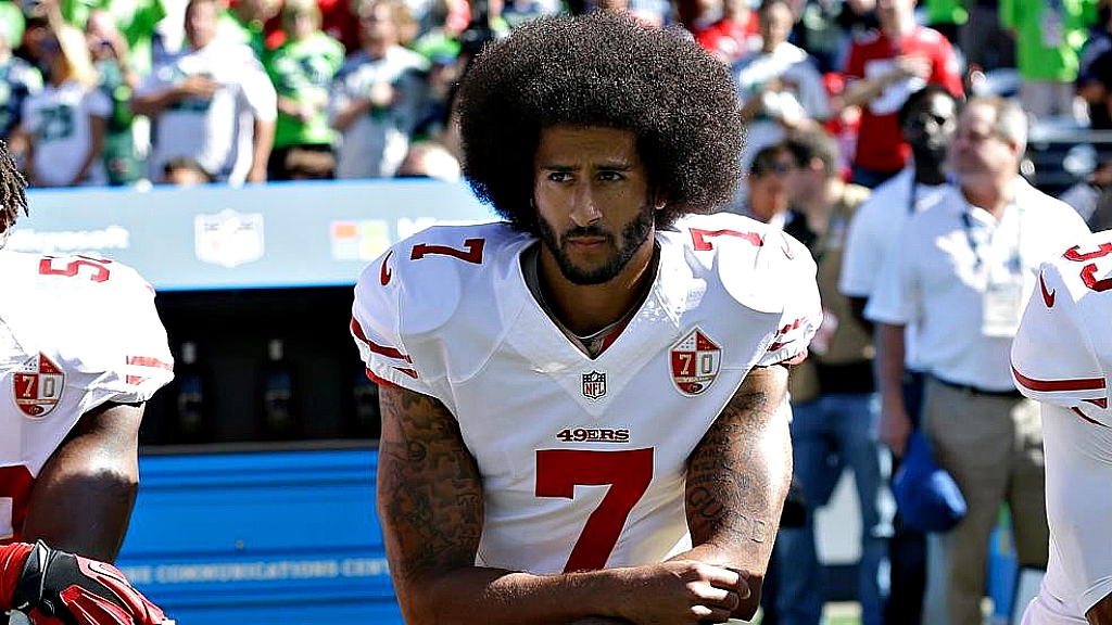 Colin Kaepernick kneels during the national anthem against social injustice