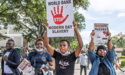 Protesters holding signs against IMF policies