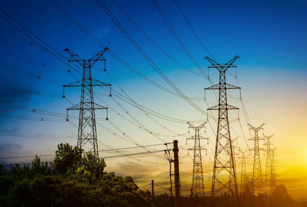 A power transmission line in Uganda, symbolizing the country’s recent 14% electricity tariff reduction driven by a stronger shilling and lower fuel import costs.