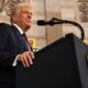 U.S. President speaking at a podium, symbolizing the global impact of presidential statements on international politics and security during times of uncertainty.