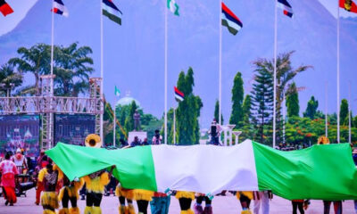 Nigerian Democracy Day celebration with citizens showing national pride and hope amid rising security concerns.