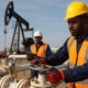African energy workers managing oil and gas infrastructure symbolizing the continent’s push for energy independence and economic empowerment without reliance on foreign aid.