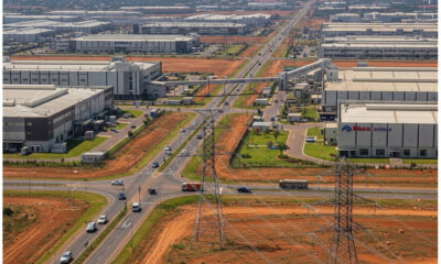 African industrial infrastructure development with factories, roads, and power lines supporting Made in Africa manufacturing.
