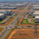 African industrial infrastructure development with factories, roads, and power lines supporting Made in Africa manufacturing.