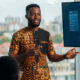 Young African tech entrepreneur presenting a digital solution, representing the continent's shift toward service-led and innovation-driven growth.