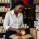 African entrepreneur packaging locally produced shea butter for export, symbolizing value addition and economic empowerment on the continent.
