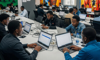 A modern African tech hub in Nairobi or Kigali, with young developers coding on laptops, challenging stereotypes and showcasing the continent’s growing digital innovation ecosystem.