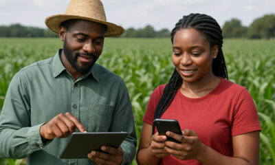 Young African farmers using digital tools in a green field, symbolizing Africa's potential to lead global agricultural innovation and food security.