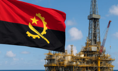 Angolan flag flying over an offshore oil rig, representing national energy sovereignty, economic growth, and Angola’s strategic use of hydrocarbons for development