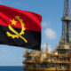 Angolan flag flying over an offshore oil rig, representing national energy sovereignty, economic growth, and Angola’s strategic use of hydrocarbons for development