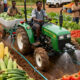 African farmers cultivating crops using modern techniques, highlighting local food production, economic growth, and youth-led agricultural innovation.