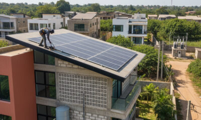 Illustration of a technician installing solar panels on an African home, providing clean energy access through decentralized renewable systems