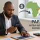 African businessman sending money to a supplier in another African country, highlighting high transaction costs and the benefits of PAPSS for faster, cheaper intra-African payments.