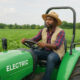 Electric tractor plowing a field in rural Africa, symbolizing sustainable mechanization, youth empowerment, and climate-smart agriculture for smallholder farmers.