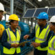 African industrial workers and engineers collaborate at a modern factory powered by renewable energy, symbolizing Africa’s shift from extractive infrastructure to value-driven industrial growth and economic transformation.