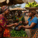 Women informal cross-border traders navigating customs at an African border checkpoint—highlighting their critical role in regional trade and the challenges of informality.