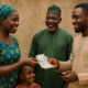 African family receives remittance money from a family member abroad, symbolizing the vital role of diaspora support in strengthening household economies across Africa.