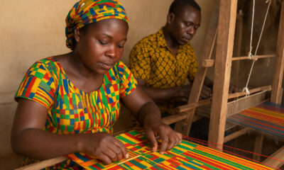 Ghanaian artisans weaving Kente cloth, symbolizing the country’s first Geographical Indication and the protection of African cultural heritage.