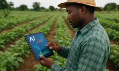 African farmer using AI-powered tools and data-driven technology in the field to improve crop yields and promote sustainable, climate-smart agriculture.