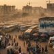 Aerial view of a congested bus terminus in an African city, symbolizing internal migration and rapid urbanization.