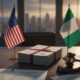 US and Nigerian flags with diplomatic documents and a gavel, symbolizing tensions over religious freedom designation and diplomatic relations between the United States and Nigeria.