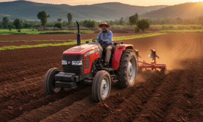 African farmer operating a tractor in a vast cultivated field, symbolizing the urgent need for agricultural mechanization to unlock Africa's farming potential and drive economic transformation.