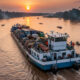 Modern barge transporting goods on the Congo River, showcasing African river transport.