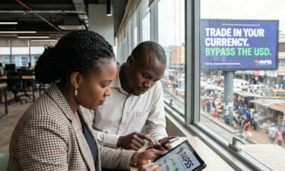 African businesspeople using digital payment platforms to send money across borders in local currencies, symbolizing the PAPSS fintech revolution reducing reliance on foreign banks and USD.