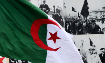Algerian flag alongside historical imagery symbolizing resistance to French colonial rule, representing Algeria's new law declaring colonialism a crime against humanity.