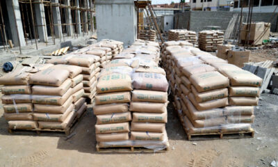 Cement bags stacked at construction site in Uganda showing industrial manufacturing challenges