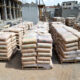 Cement bags stacked at construction site in Uganda showing industrial manufacturing challenges