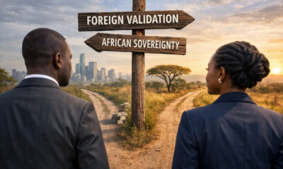 African professionals in suits standing at a crossroads - one path labeled "foreign validation," the other "African sovereignty" - symbolizing the choice between elite complicity and courageous, self-determined leadership.