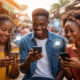African youth using smartphones and mobile technology, symbolizing digital inclusion and economic opportunity across the continent