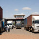 Trucks and cargo at West African border crossing illustrating regional trade.