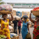 African women and youth traders transporting goods across a border, symbolizing informal cross-border trade and the role of the AfCFTA in Africa’s economic integration.