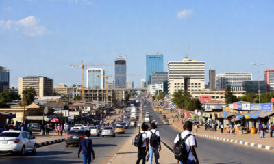Bustling African street, construction sites, and young people - representing rapid urbanization driving economic growth across the continent.