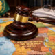A gavel rests on a map of Africa, symbolizing the debate over legal enforcement for the AfCFTA single market.