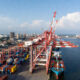 African port with cargo cranes and ships illustrating Chinese investment transforming global trade infrastructure.
