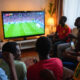 African football fans watching World Cup match on television from home due to visa restrictions