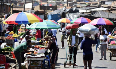 Informal traders and small businesses operating in township markets in South Africa, illustrating the country’s large informal economy behind falling unemployment figures.