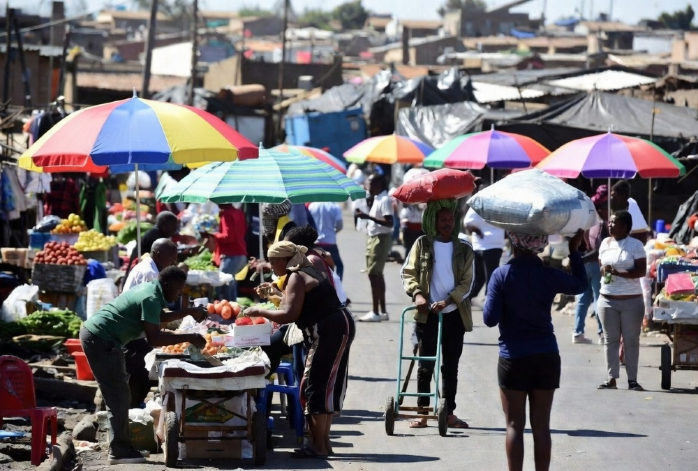 Informal traders and small businesses operating in township markets in South Africa, illustrating the country’s large informal economy behind falling unemployment figures.