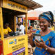 A person in Africa using a mobile phone to receive a remittance payment from a family member overseas.