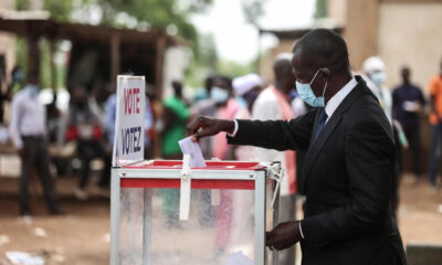 A voter casting a ballot in Africa, representing the 2026 elections that will filter disciplined multinational capital from undisciplined investment.