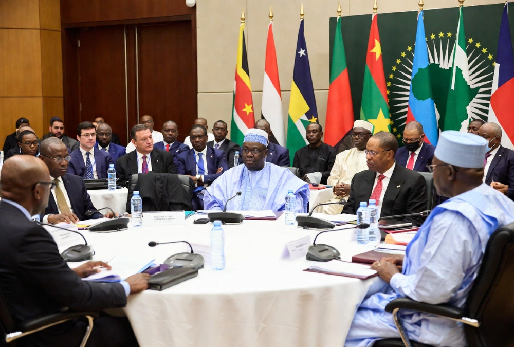 African leaders and international diplomats gathered at a summit table, representing the continent's growing role in middle power mediation and conflict resolution