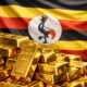 Gold bars stacked with Uganda flag in background illustrating surge in Uganda’s gold exports surpassing coffee in 2025