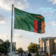 Please generate a realistic image of dimensions 1536 by 1024 from the following theme: Zambian flag with digital data streams symbolizing data sovereignty and refusal of US aid conditions.