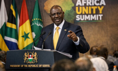 Kenyan President William Ruto addressing a summit, proposing a unified African foreign policy to overcome the continent's historical client-state dependency.