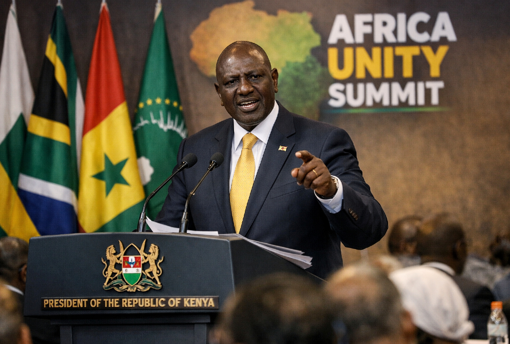 Kenyan President William Ruto addressing a summit, proposing a unified African foreign policy to overcome the continent's historical client-state dependency.
