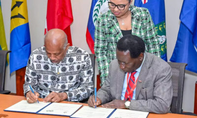 UWI Vice-Chancellor Hilary Beckles and CVNU Secretary General Andrew Haruna signing MoU at UWI Regional Headquarters in Jamaica