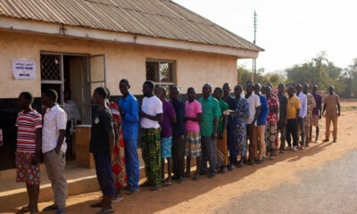 African citizens voting in an election, highlighting the democracy trap where ballots exist but real political and economic power remains limited.